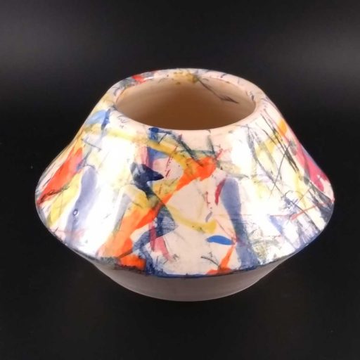 Image of a geometric pot decorated with splashes of colour