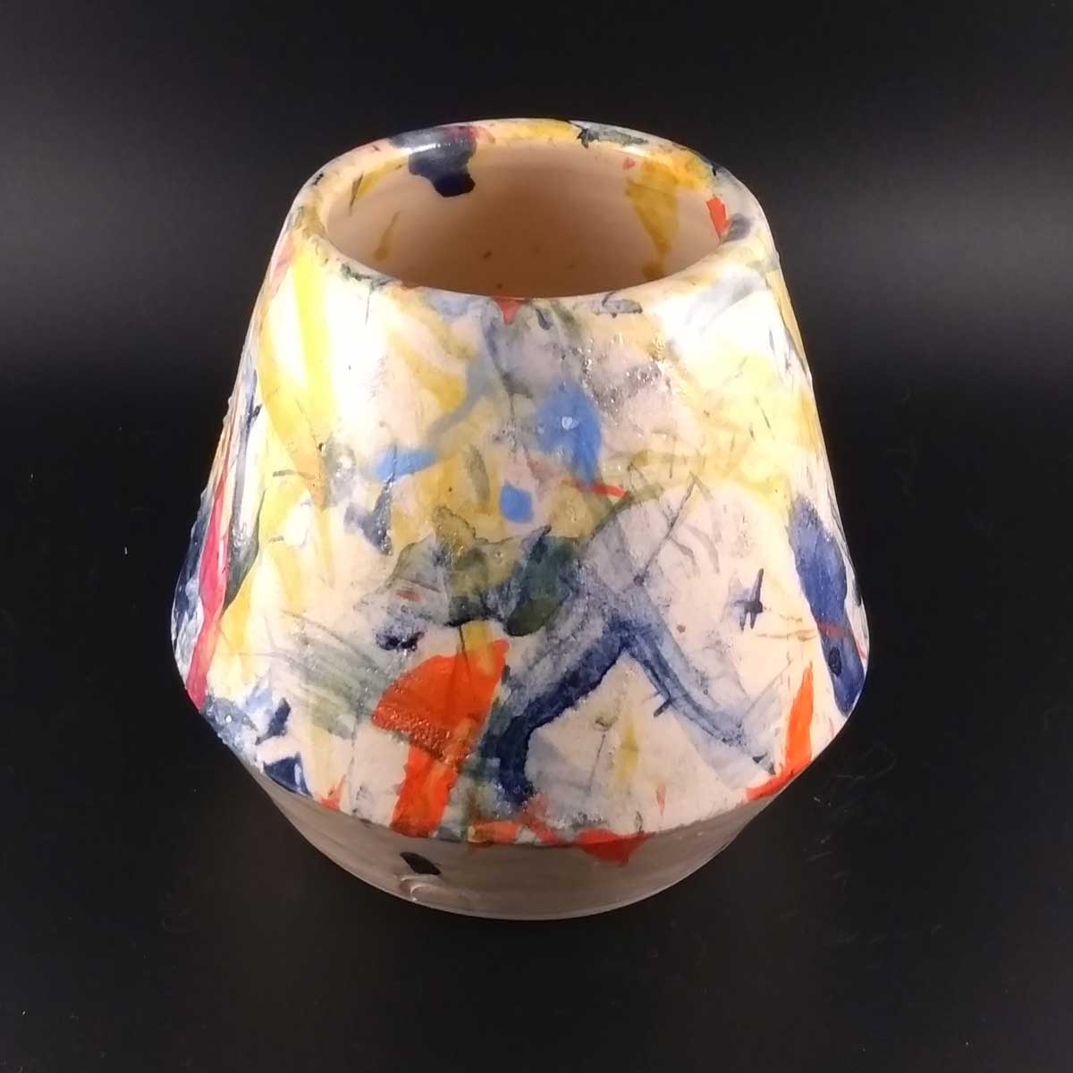 Image of a geometric pot decorated with splashes of colour
