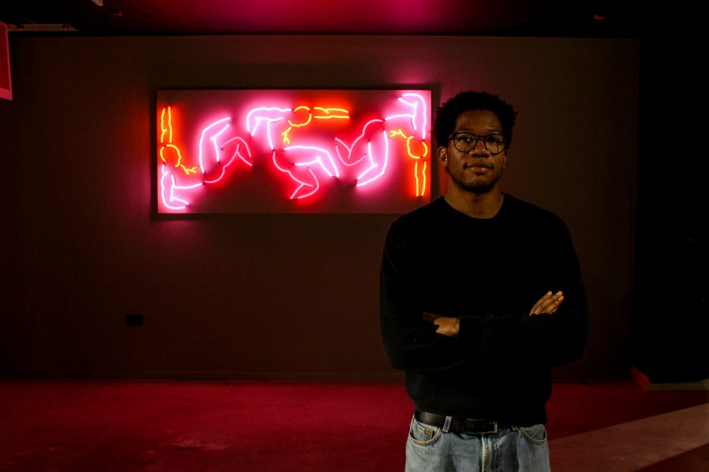 A portrait of Myles-jay Linton and his artwork.